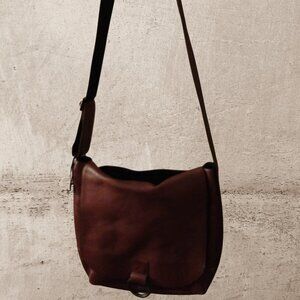 A brown leather crossbody saddle bag